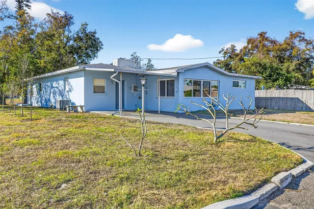 a house view with a swimming pool and a yard