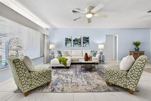 a living room with furniture or couch and a chandelier