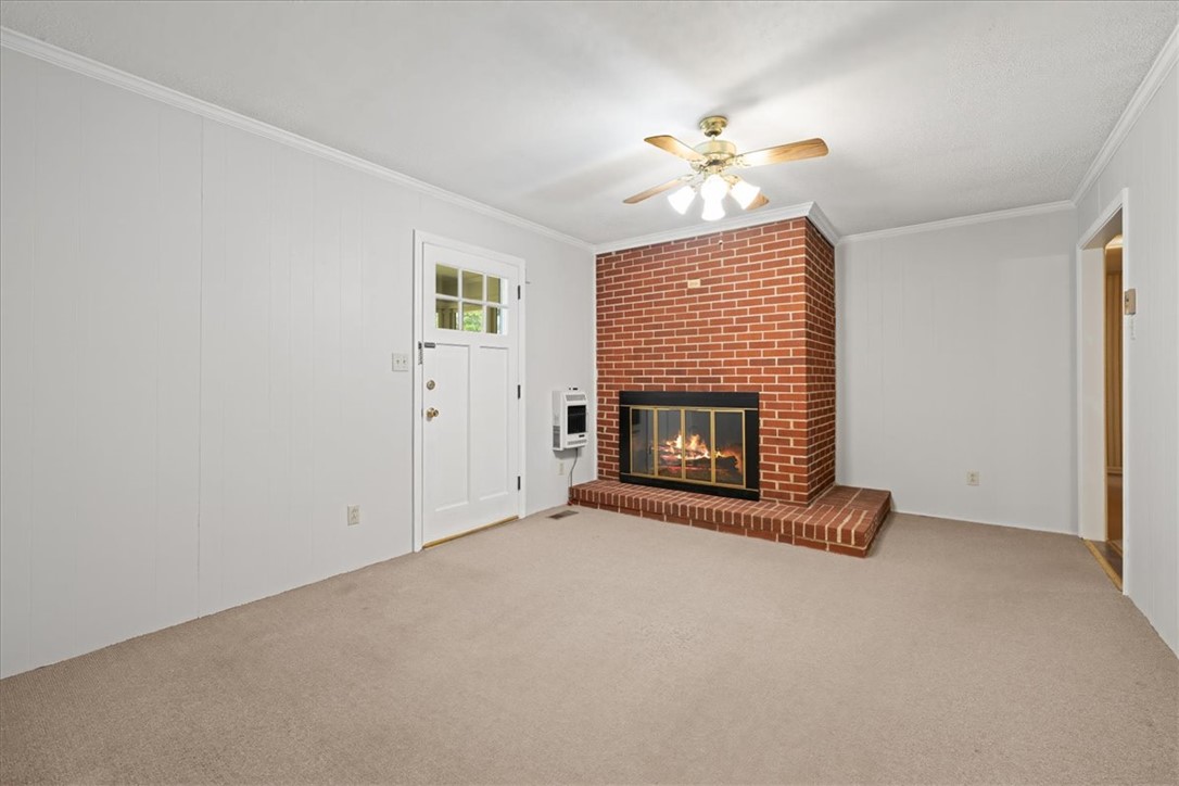 304 Shaw Road Honea Path, SC 29654 - Photo 7 of 39 This cozy living area features a charming brick fireplace, perfect for relaxing evenings.