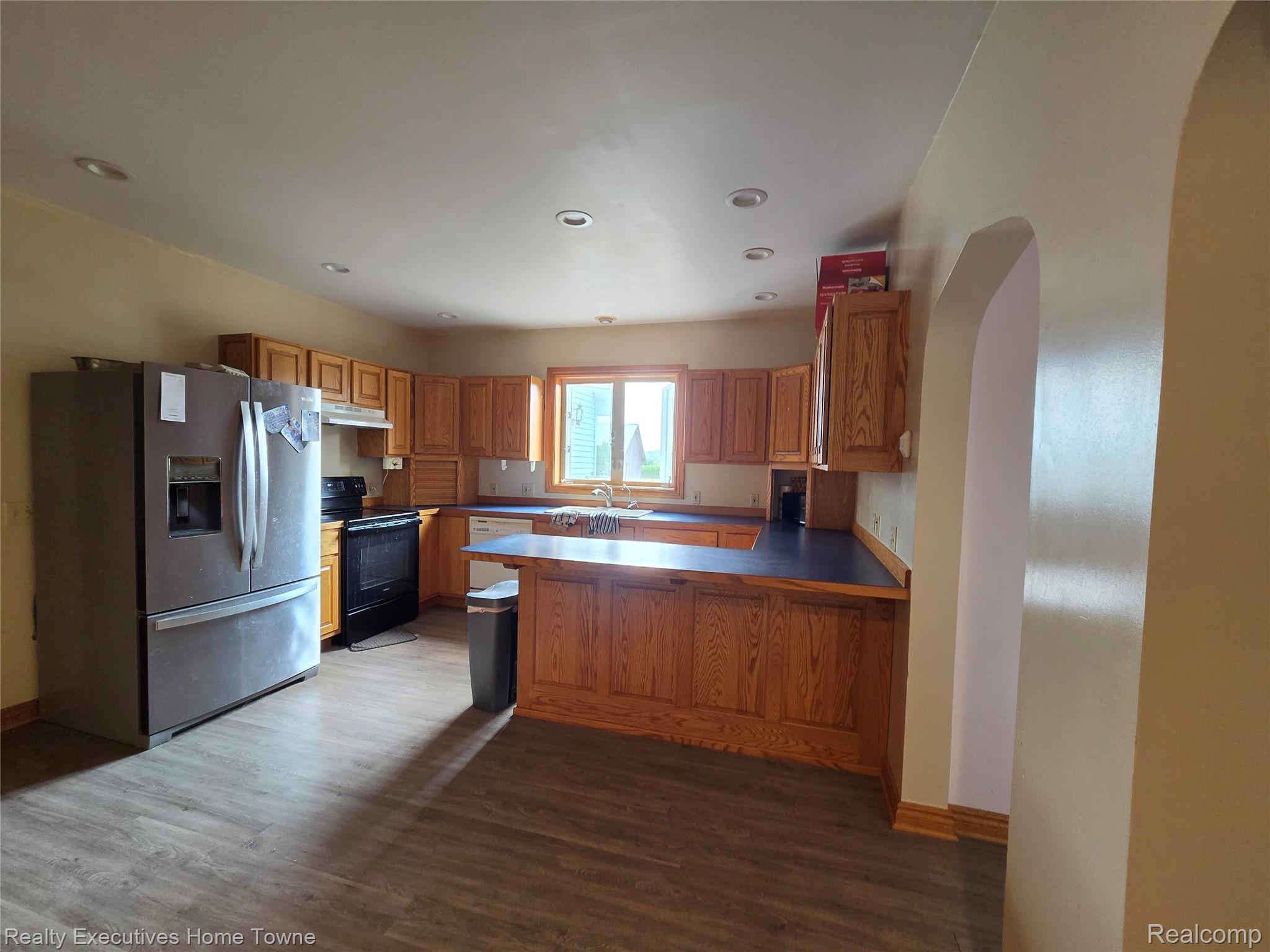2715 Cash Road Applegate, MI 48401 - Photo 29 of 59 Kitchen featuring wood-finish flooring, recessed lighting, wood cabinetry, and a peninsula with dark countertops