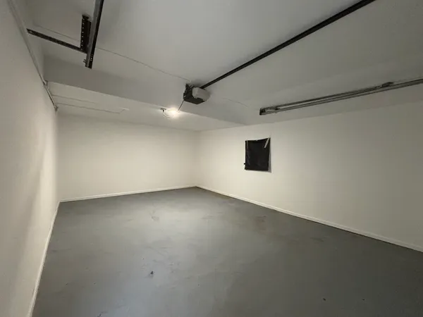 an empty room with a empty space and windows