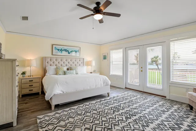 a bedroom with a bed and a large window