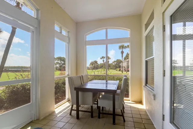 a view of a dining room with furniture large windows and wooden floor