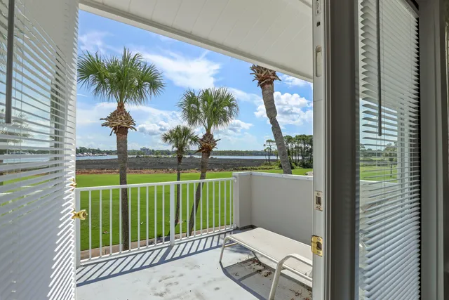a view of a balcony with lake view and a potted plant