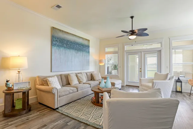 a living room with furniture and a chandelier
