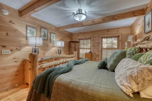 a bathroom with a granite countertop sink a mirror and shower