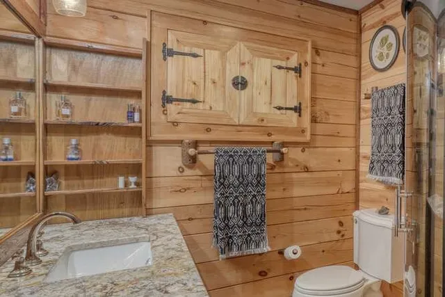 a bedroom with a bed a chandelier and flat screen tv