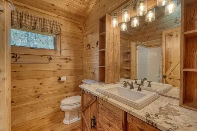 a backyard of apartments with large trees and wooden fence