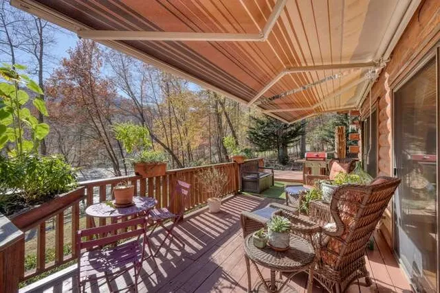 a backyard of a house with table and chairs