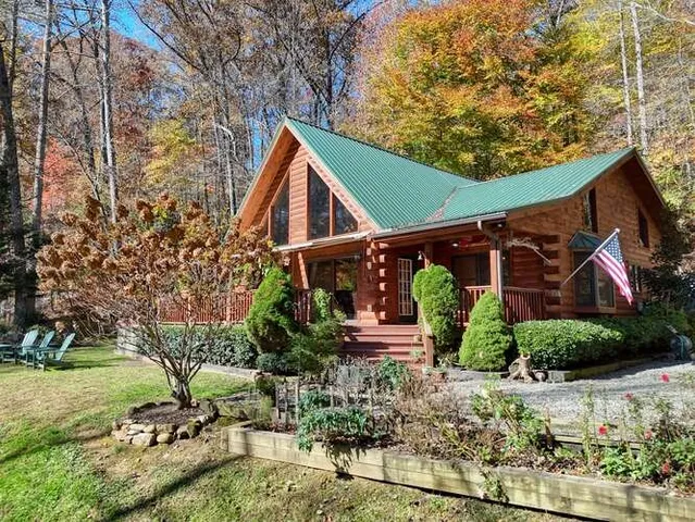 a living room with furniture fireplace and a large window