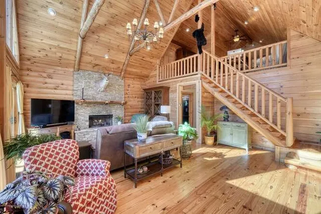 a living room with furniture a flat screen tv and a floor to ceiling window
