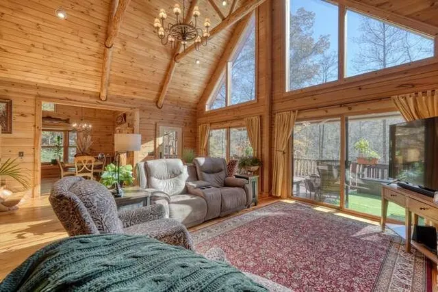 a kitchen with stainless steel appliances kitchen island granite countertop a stove a sink a refrigerator white cabinets with wooden floor