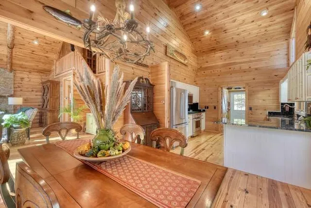 a kitchen with stainless steel appliances a stove a sink dishwasher a microwave oven with cabinets and wooden floor