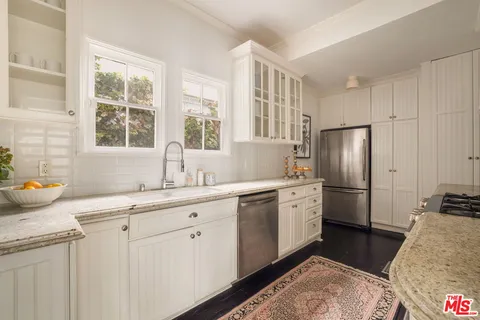 a kitchen with a sink stove and refrigerator