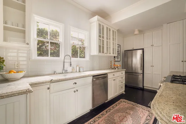 a kitchen with a sink stove and refrigerator