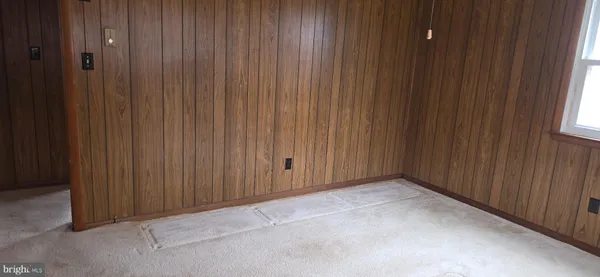 a view of an empty room with a wooden door