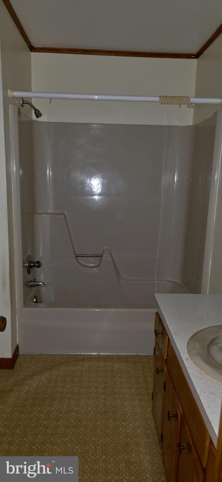 117 Howard Road Stevensville, MD 21666 - Photo 8 of 12 a bathroom with a shower and a sink
