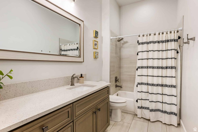 4222 Hampshire Road Hurricane, UT 84737 - Photo 9 of 12 Bathroom featuring a neutral color palette, a rectangular framed mirror, a vanity with a light-colored countertop, and a shower-over-tub combination with a tiled surround