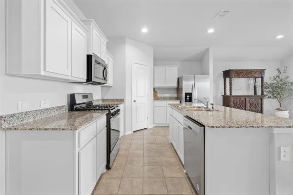 a kitchen with furniture and a stove top oven
