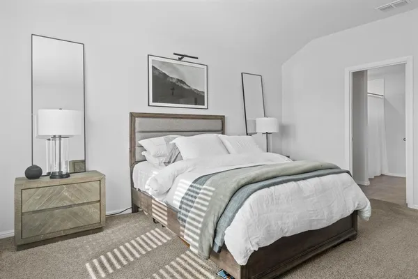 a bedroom with furniture and a flat screen tv