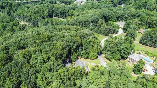 an aerial view of residential house with yard and outdoor space