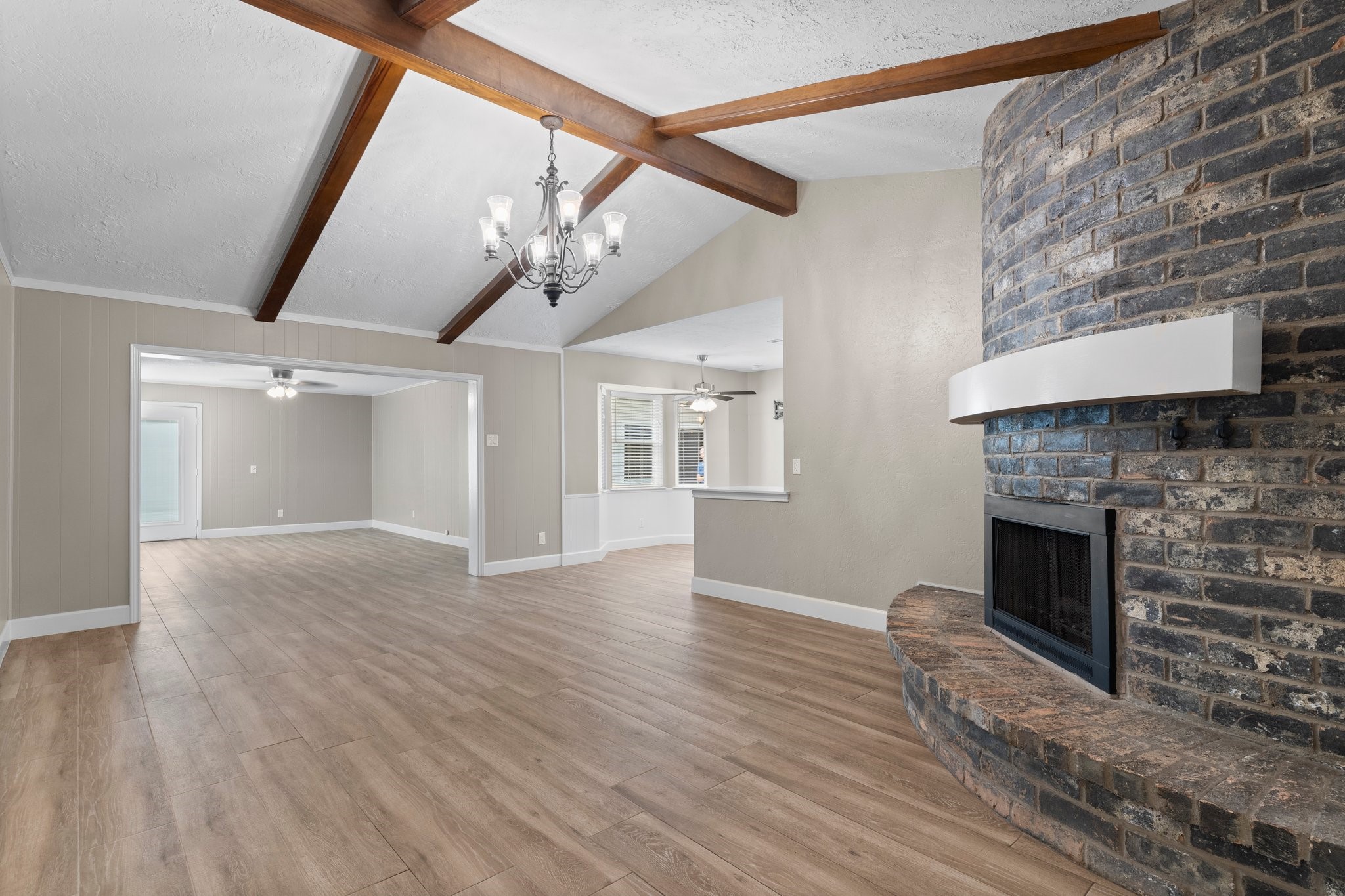 27234 Wells Lane Conroe, TX 77385 - Photo 5 of 15 a view of an empty room with wooden floor and a fireplace
