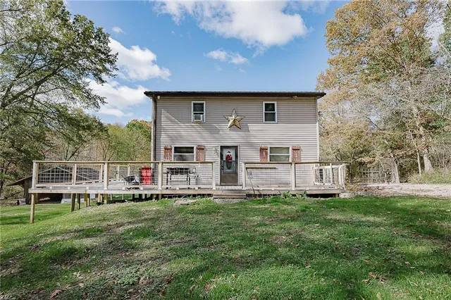 a house view with a sitting space and garden