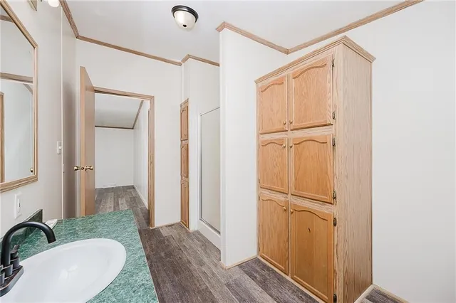 a view of a bathroom with mirror and door