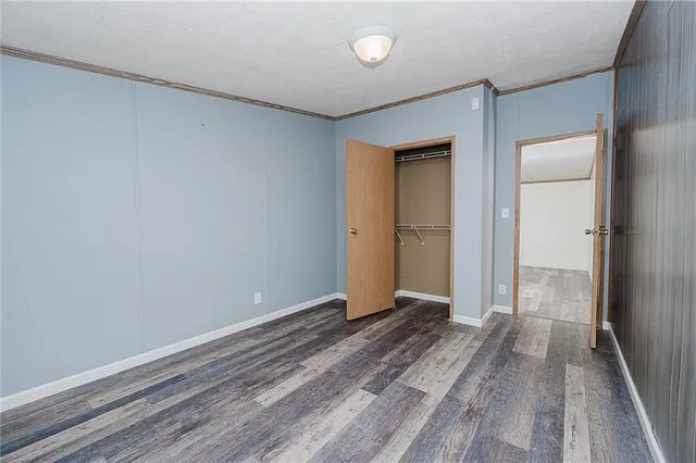 a view of an empty room and wooden floor