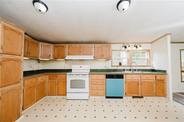 a kitchen with stainless steel appliances granite countertop a refrigerator sink and cabinets