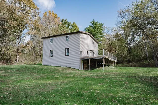 a view of house with backyard