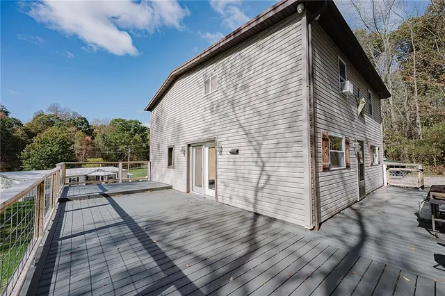 a view of house with backyard and sitting area