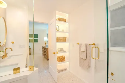 a bathroom with a tub sink and mirror