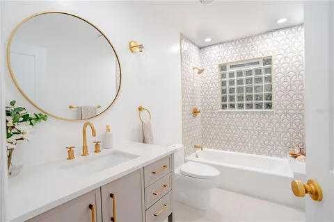 a bathroom with a sink a toilet and a mirror