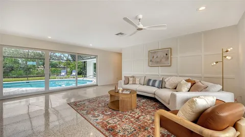 a living room with furniture and a floor to ceiling window