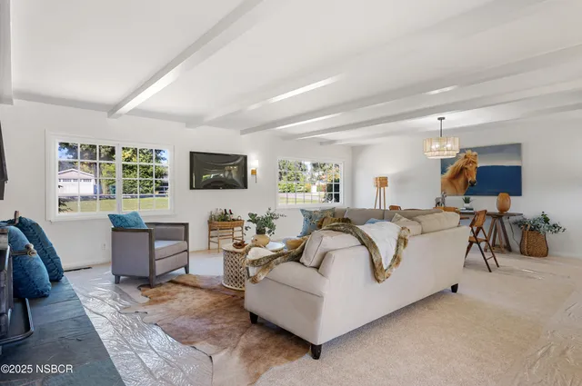 a kitchen with a sink a stove and a clock on the wall