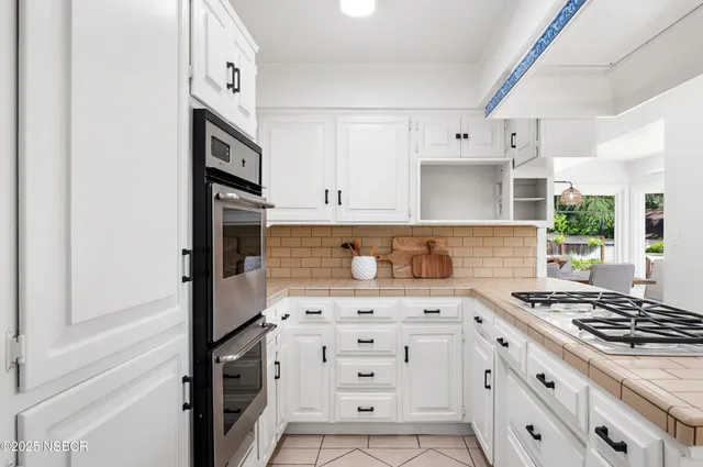 a view of a livingroom with furniture and mirror