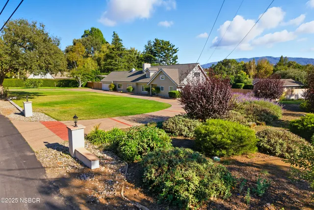 a view of a garden with a building in the background