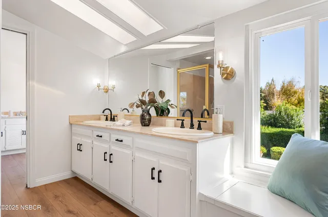 a view of a patio with couches and a table and chairs with wooden fence
