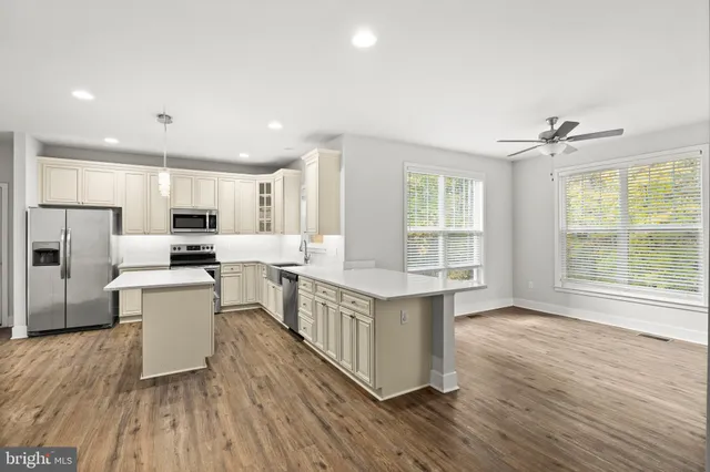 a view of a room with window and ceiling fan