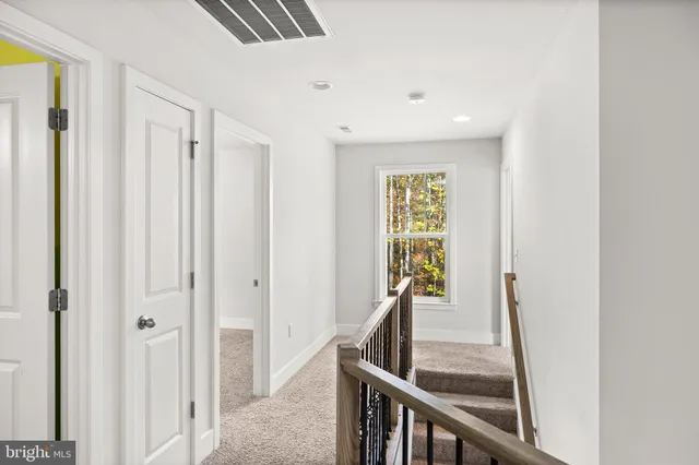 a white bath tub sitting in a bathroom next to a window