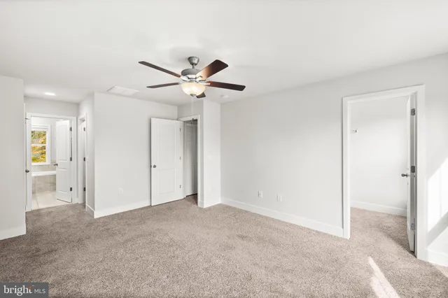 a view of a house with a small yard and wooden floor and fence