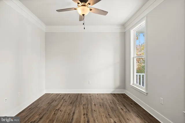 a view of a room with wooden floor and chandelier