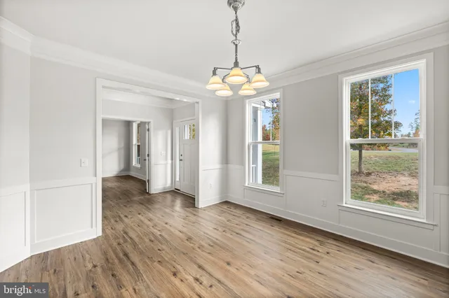 a kitchen with a sink a counter top space stainless steel appliances and a window