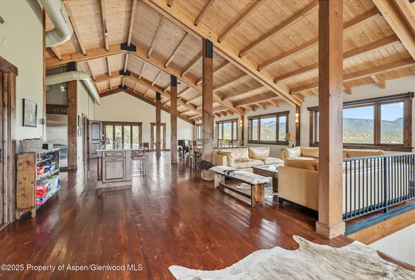 a living room with lots of furniture and wooden floor