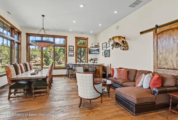 a living room with furniture and a floor to ceiling window