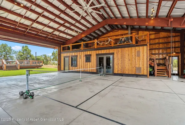 a porch with a table and chairs