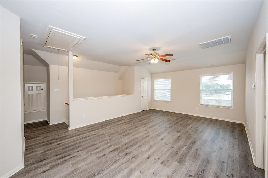 18914 Appletree Ridge Road Houston, TX 77084 - Photo 17 of 31 an empty room with wooden floor and windows