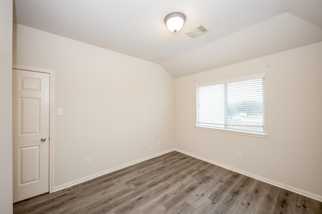 18914 Appletree Ridge Road Houston, TX 77084 - Photo 22 of 31 an empty room with wooden floor and windows