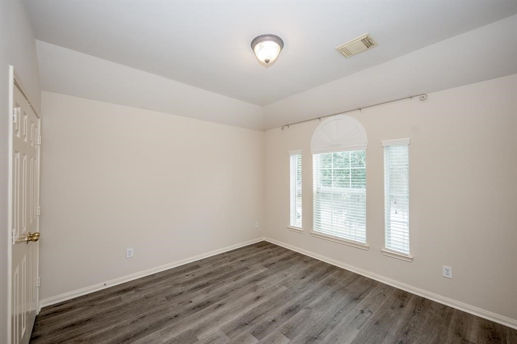 18914 Appletree Ridge Road Houston, TX 77084 - Photo 24 of 31 a view of an empty room with wooden floor and a window